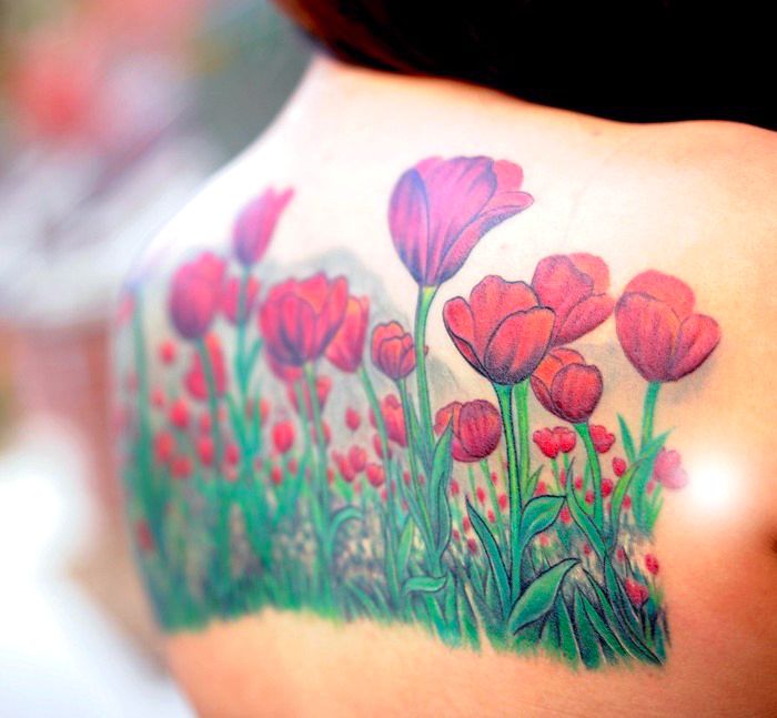 veľké kvetinové tetovanie na zadnej strane, tetovanie s mnohými makami