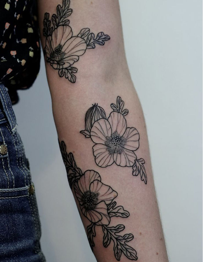 Znaczenie tatuażu, wiele małych kwiatów w kolorze czarnym i szarym na całej ramieniu