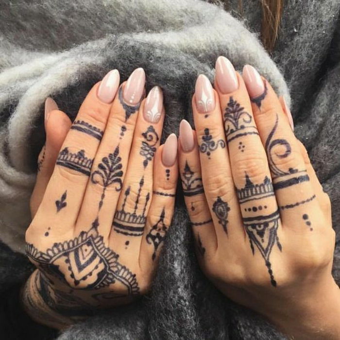 Žena s tetovacími prstami na oboch rukách, indický štýl henna tetovanie s mnohými bodmi v čiernej farbe