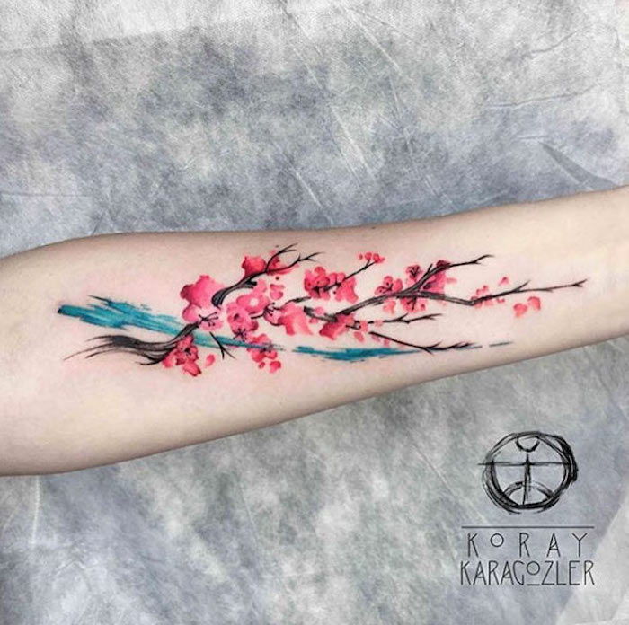 sensul tatuajului, tatuaj colorat pe antebraț, ramură cu flori de cireșe
