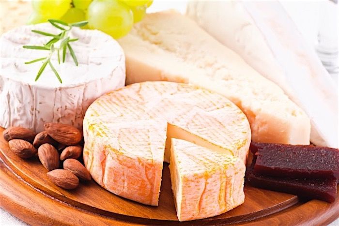 Brie ve Camember peyniri, parmesan büyük bir parça, çiğ köfte ve beyaz şarap üzümleri süs olarak, iki parça Türk Patirma