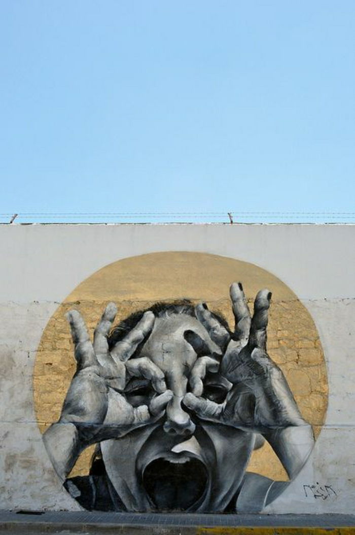 Graffiti ściana Himmer dziecko hands-eyes dziwne znaki mesa Hiszpania