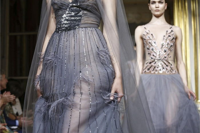 Couture šaty v šedej tylovej tkanine s aplikáciami a trblietavými pruhmi, hore s záhybmi a trblietkami