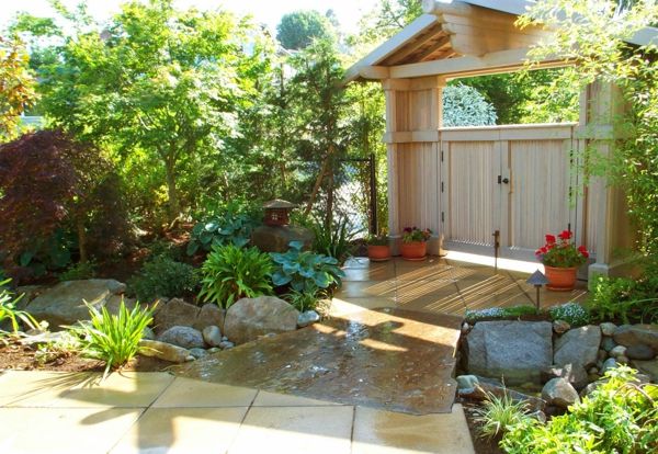 Podwórko z dużymi drewnianymi drzwiami i zielonymi roślinami