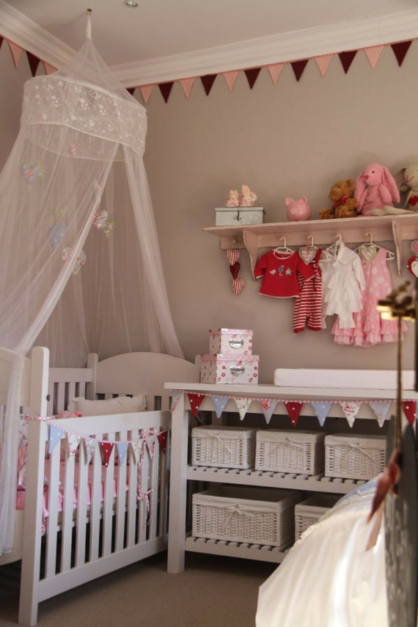 Cabide de roupas com cortinas transparentes no quarto do bebê