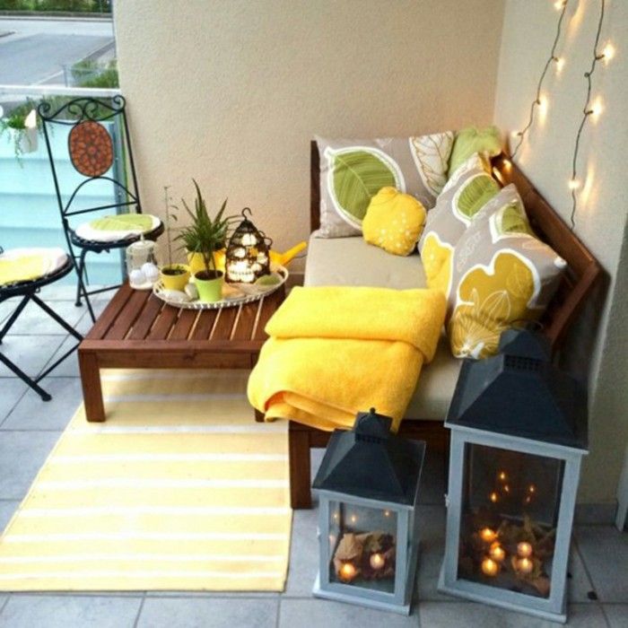 balcon de design-mediteranean-lemn-banc din lemn de masă solid galben covor-podea gresie-perna plante auto metal scaune pentru lumânări