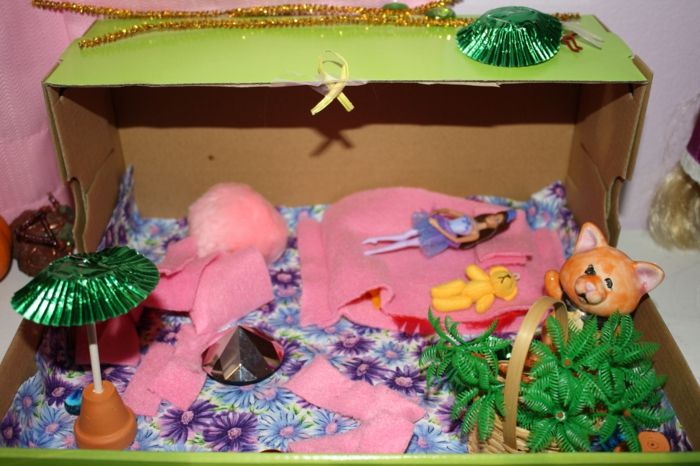 Schoenendoos maakt een huis voor het speelgoed en poppen in roze kleur