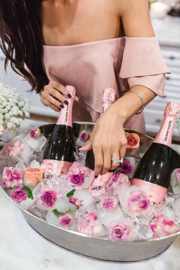 pavasario apdaila, šampanas, ledai su gėlėmis, rožinė suknelė, žiedas, juodi plaukai