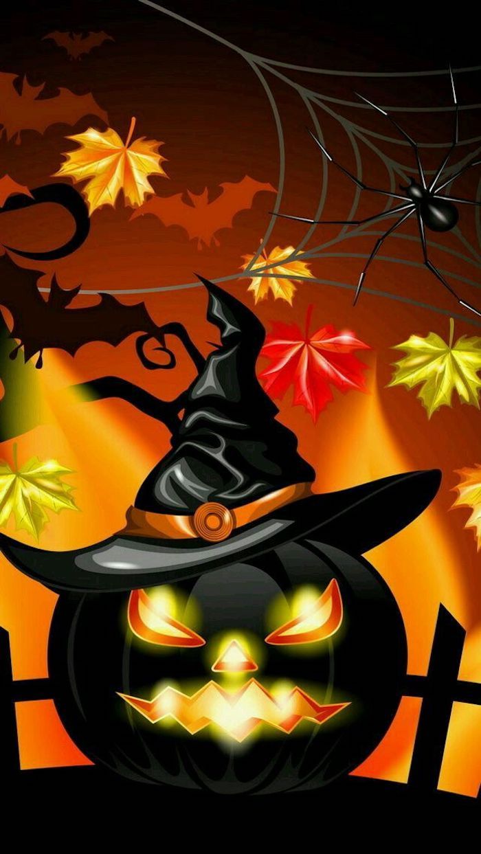et svart halloween gresskar med heksehatt og lite fargerike blader rundt den
