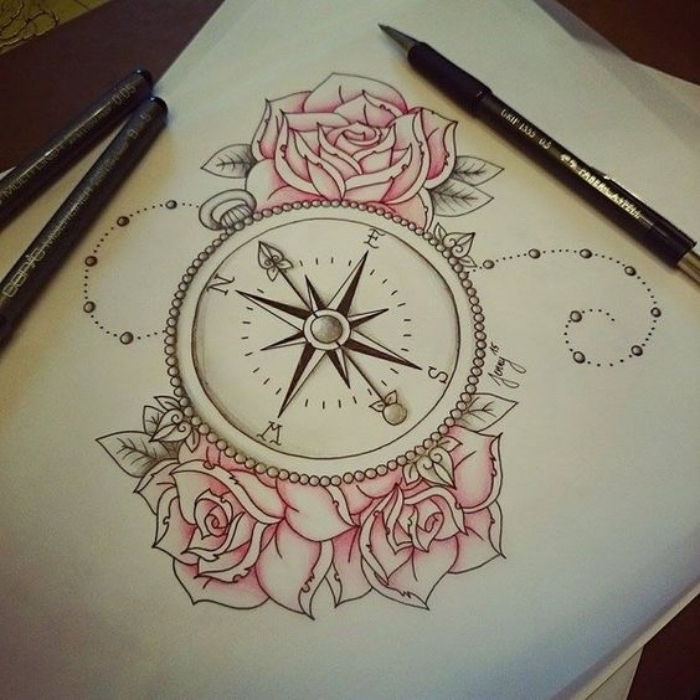 Arkusz papieru i trzy piękne różowe róże i pomysł na tatuaż kompasu