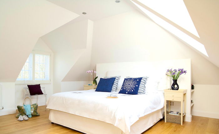 Bevel dizaino idėjos didelė lova miegamajame balta lova mėlynos pagalvės
