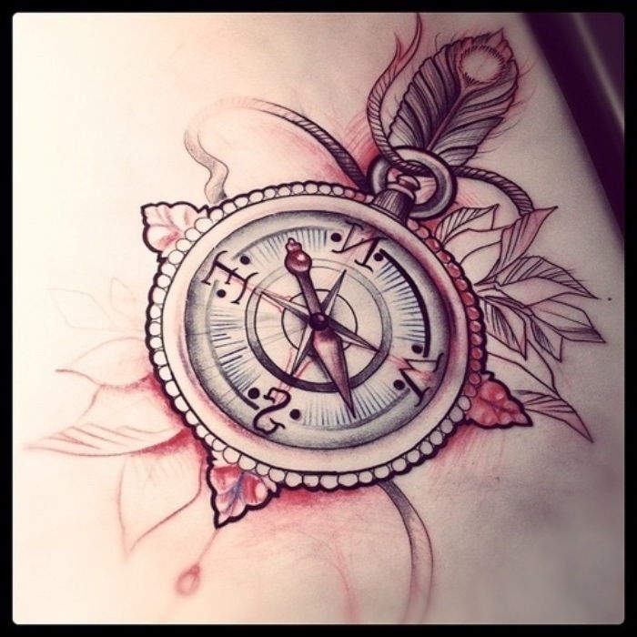 Iată un tatuaj roșu cu o busolă mare, cu o pene mică și frunze albe și flori roșii mici
