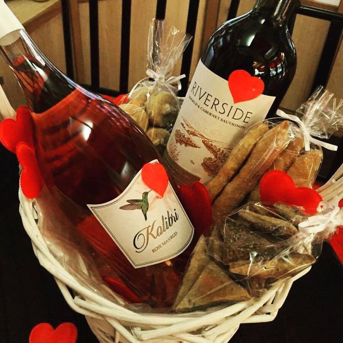 presentkorg med två vinflaskor, rött vin och ros, godis