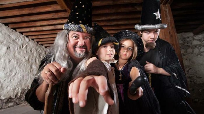 kostýmová skupina kúzelníkov - dvaja chlapci, dievča a dedko