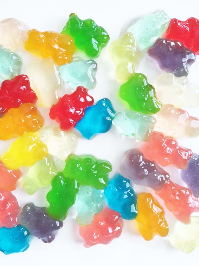 Gjør gummy bears seg i grønn, gul, blå og rød på et hvitt bord
