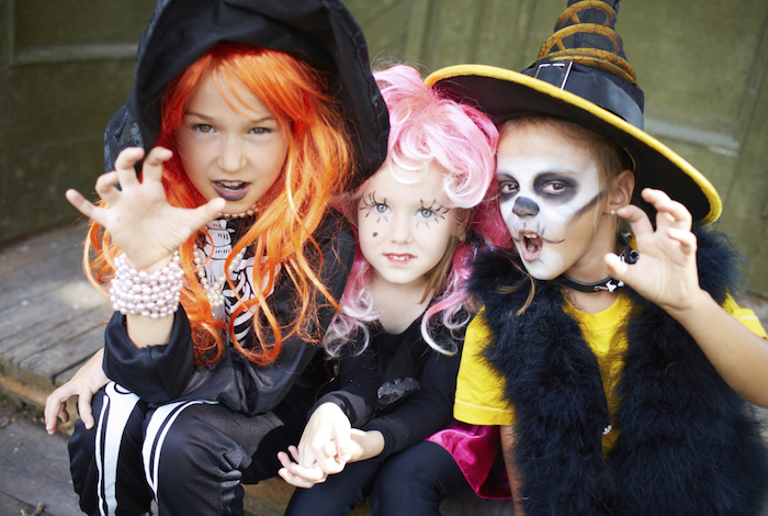 Costum de Halloween pentru copii - două fete și un băiat îmbrăcat ca niște vrăjitoare