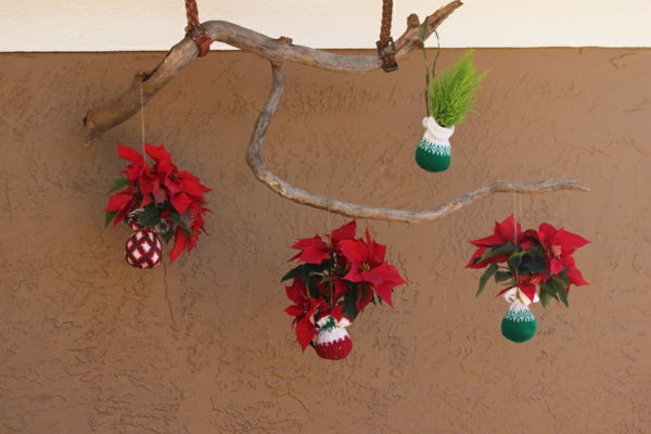 dekoracja ogrodu na ścianę - gałąź drzewa z ciekawymi elementami dekoracyjnymi