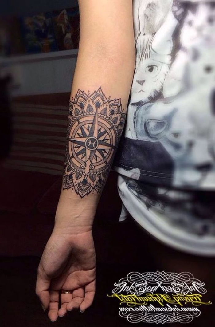 Odlična ideja za malo črno tetovažo z mandalnim kompasom na roki