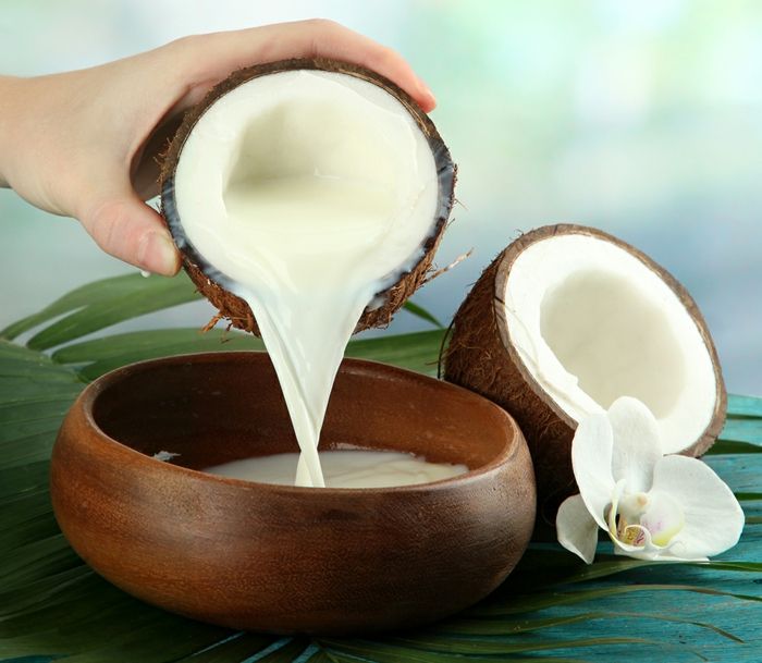Kokosové mlieko je známe ako prírodný regenerátor vlasov, kokosový orech, drevená misa, biela orchidea