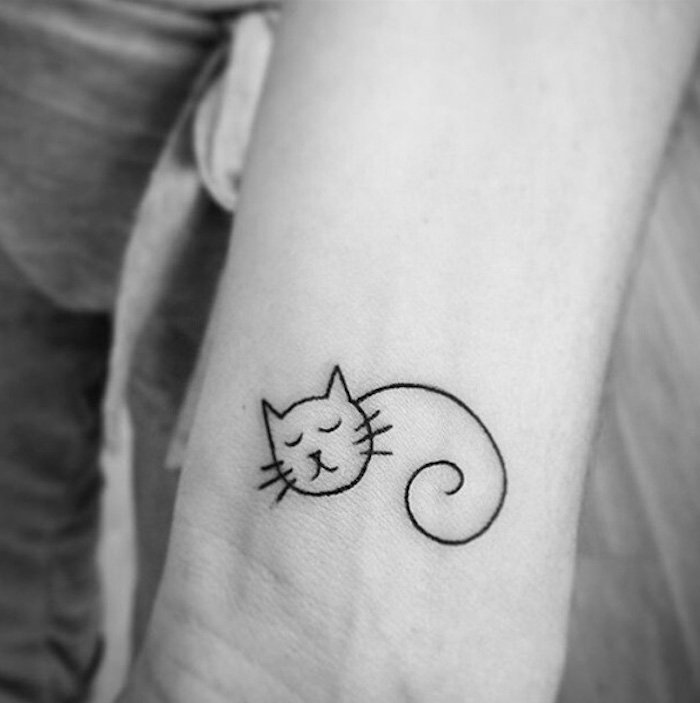 o idee minunata pentru un tatuaj de pisica pe incheietura mainii - aici este o pisica de dormit mica cu vibratii lungi