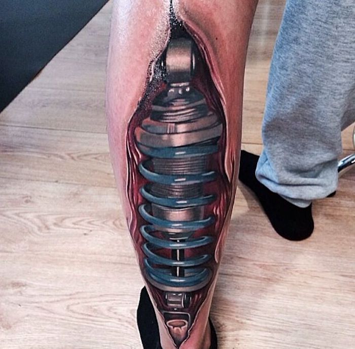 mannen tatoeages, tatoeage met machine-onderdelen op het been