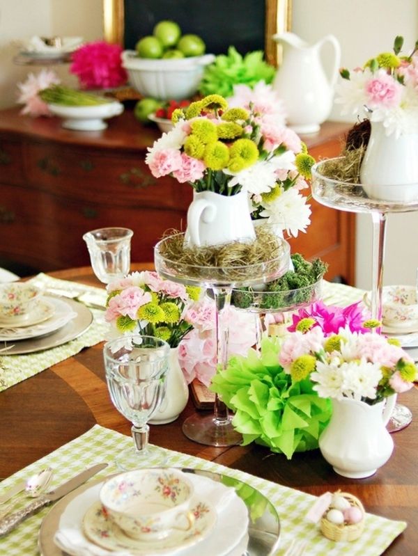 Papuoškite stalą su stiklinėmis vazomis ir daugybe guminių gėlių