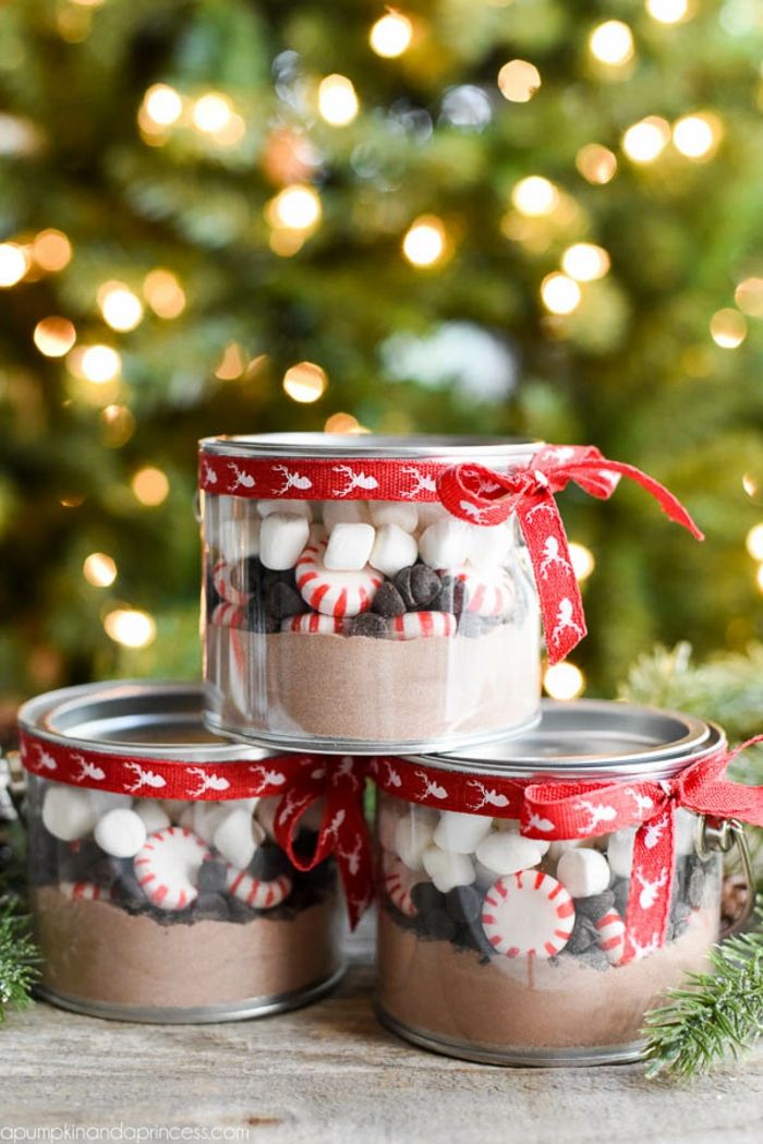 Puikios kalėdinių dovanų idėjos, šokoladiniai milteliai, saldainiai ir zefyrai dėžutės, papuošti raudona juostele