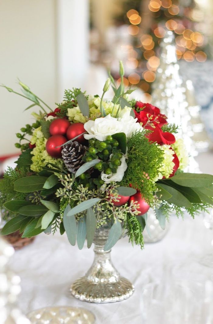 en silvervase med röda bollar och koner, vita blommor - gör arrangemang själva